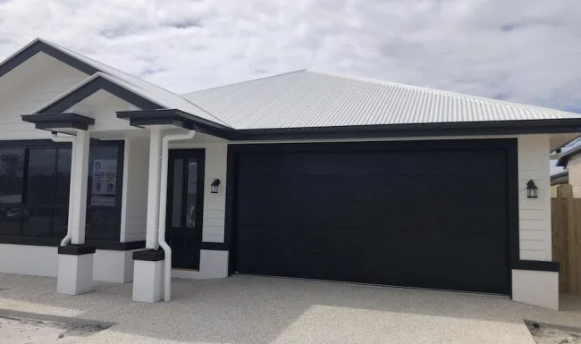 Wide flatline garage door with a dark woodgrain finish